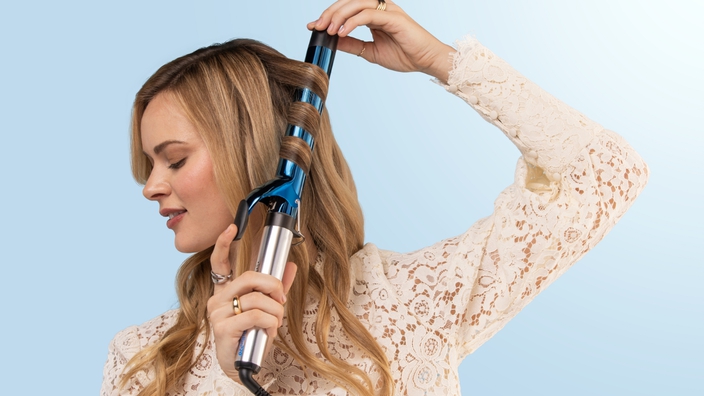 woman using babylisspro hair curling iron